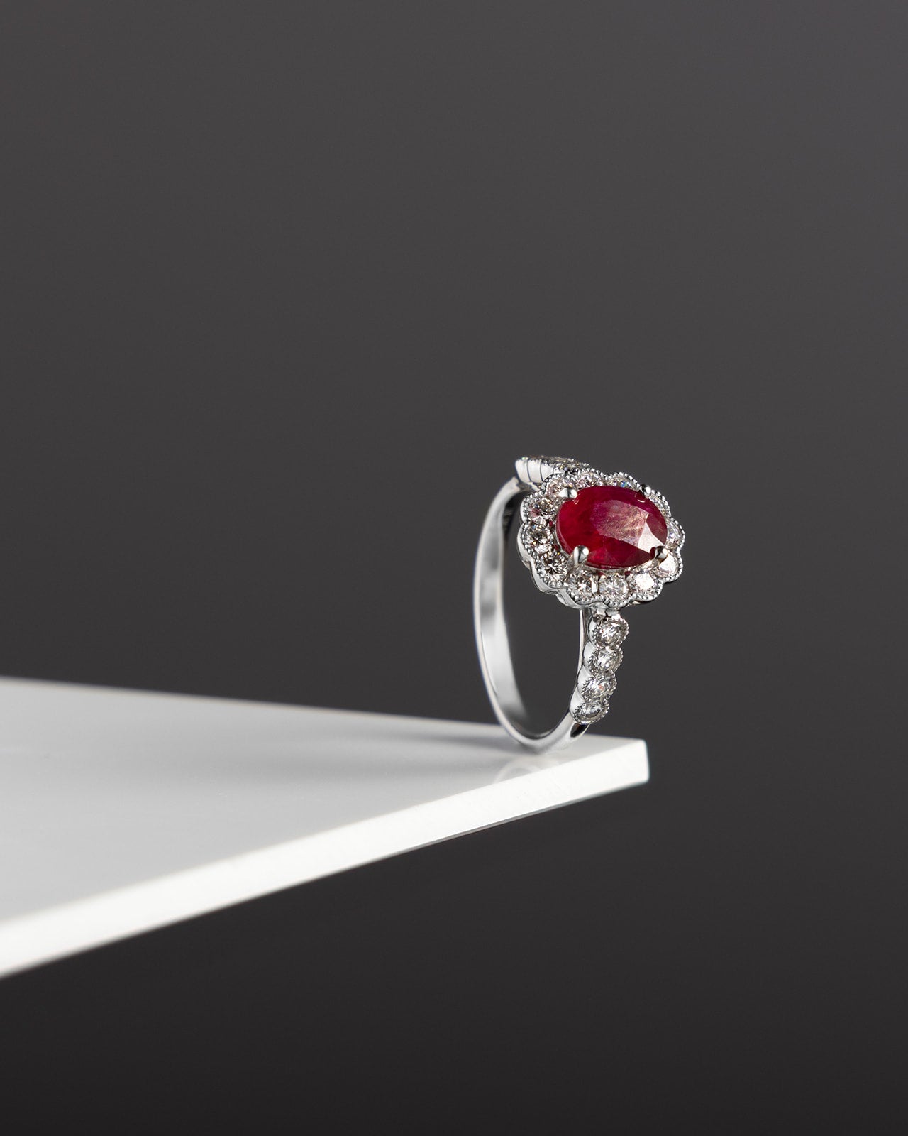 Oval Ruby and Diamond Halo Ring in White Gold