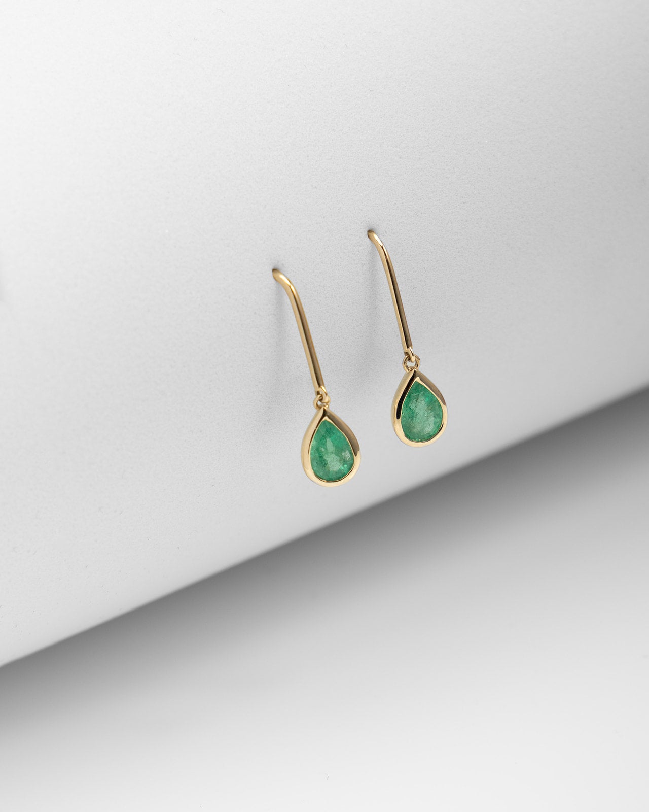 Pear Emerald Bezel Dangle Earrings in Yellow Gold