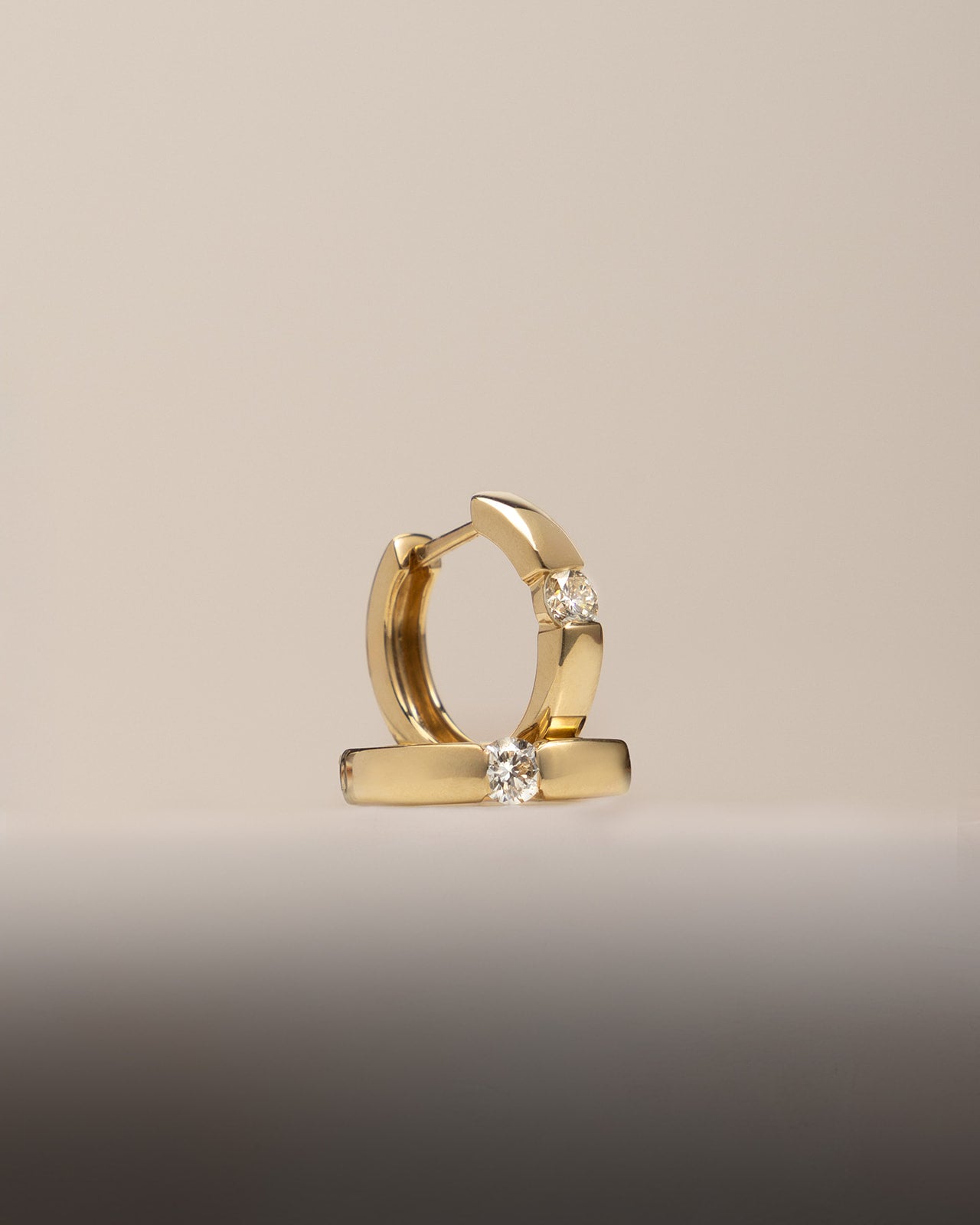 Center Diamond Huggie Earrings in Yellow Gold