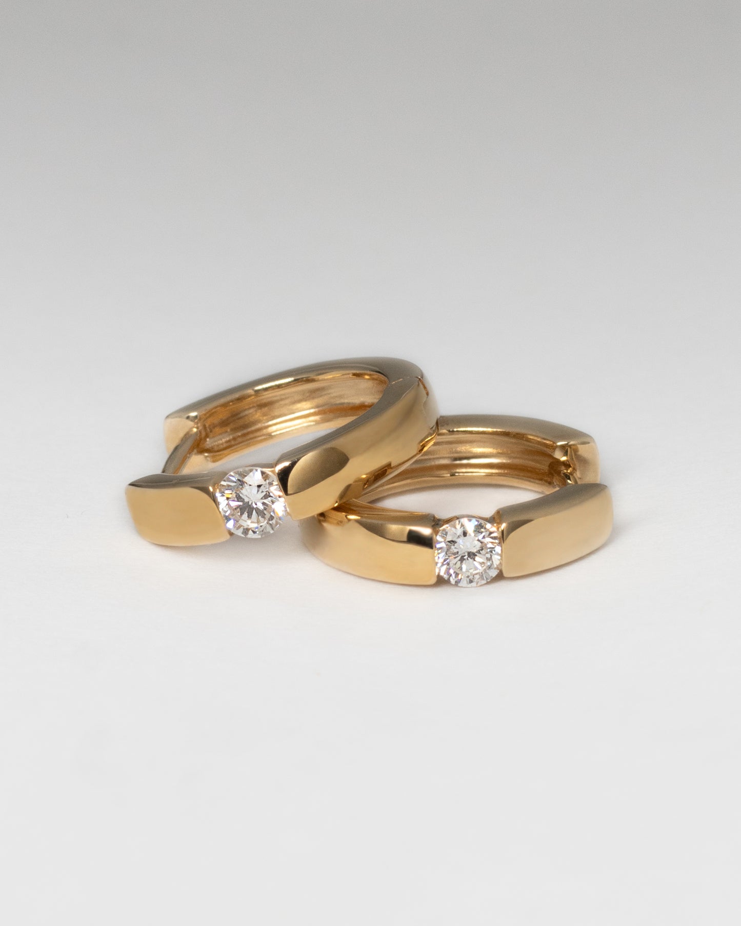 Center Diamond Huggie Earrings in Yellow Gold